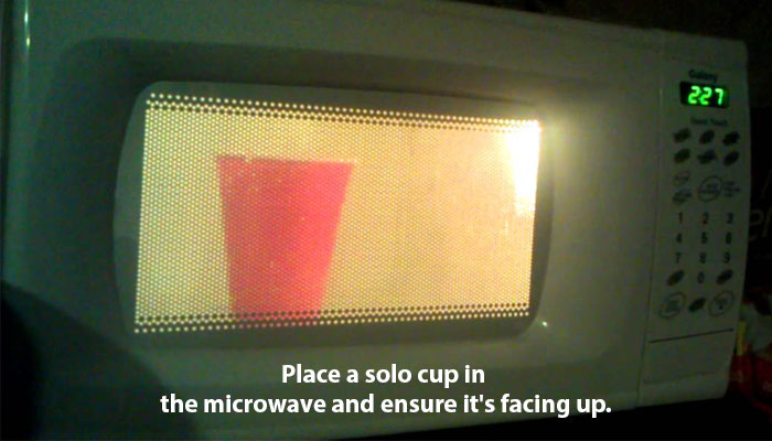 Place a solo cup in the microwave and ensure it's facing up.